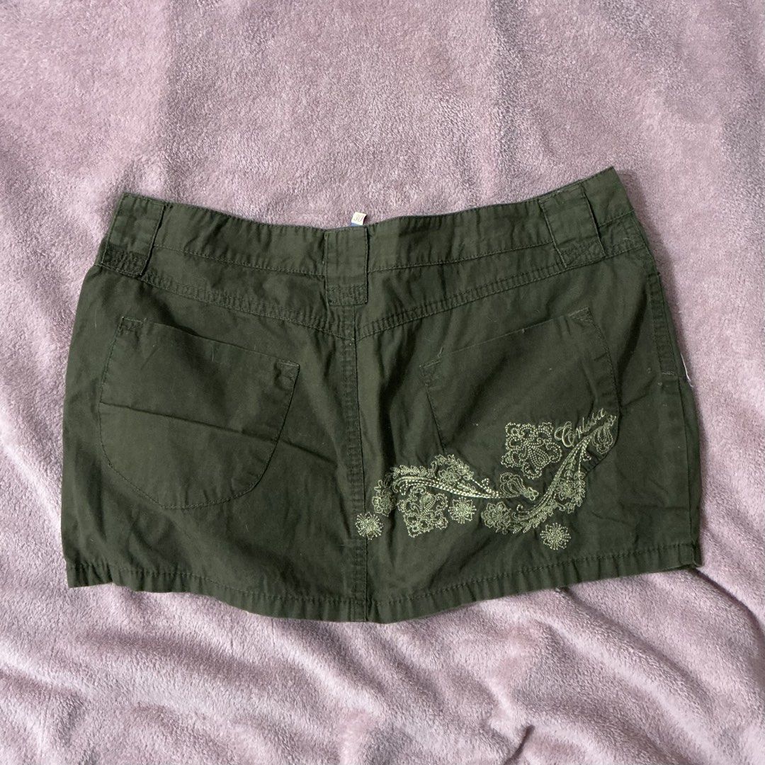 Green Mini Skirt with Embroidery (Category: Skirts) located in Manila. Submitted by fierceriver.238b8c (Listing ID 1437656400, Image 1). Description: - Dark green mini skirt - Front pockets and button details - Embroidered floral design on the back - Two back pockets - Classic, casual style - Durable fabric.