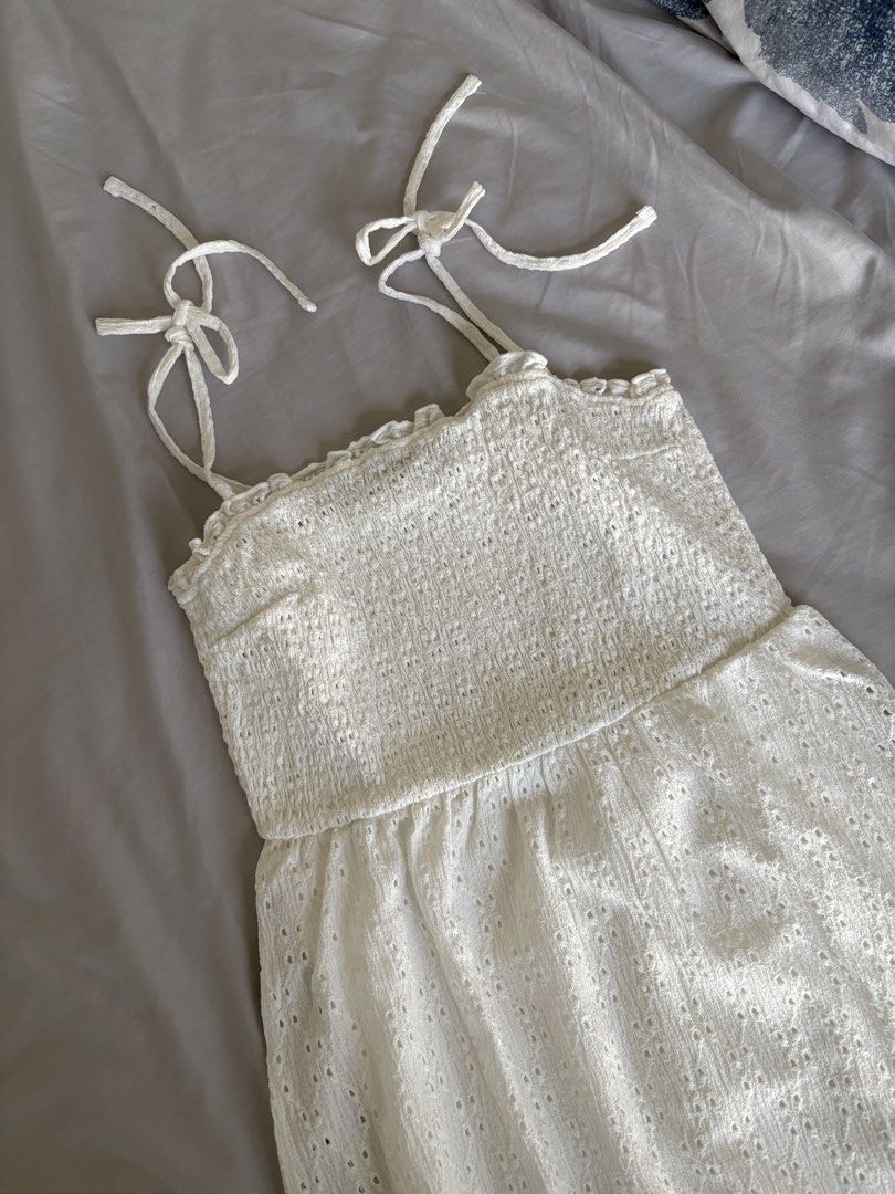 H&M White Dress (Category: Dresses) located in Angeles City. Submitted by classictop (Listing ID 1437733810, Image 1). Description: - H&M Divided white midi dress - Size: S - Features: - Smocked bodice - Flowy skirt with eyelet detailing - Perfect for casual or summer occasions.