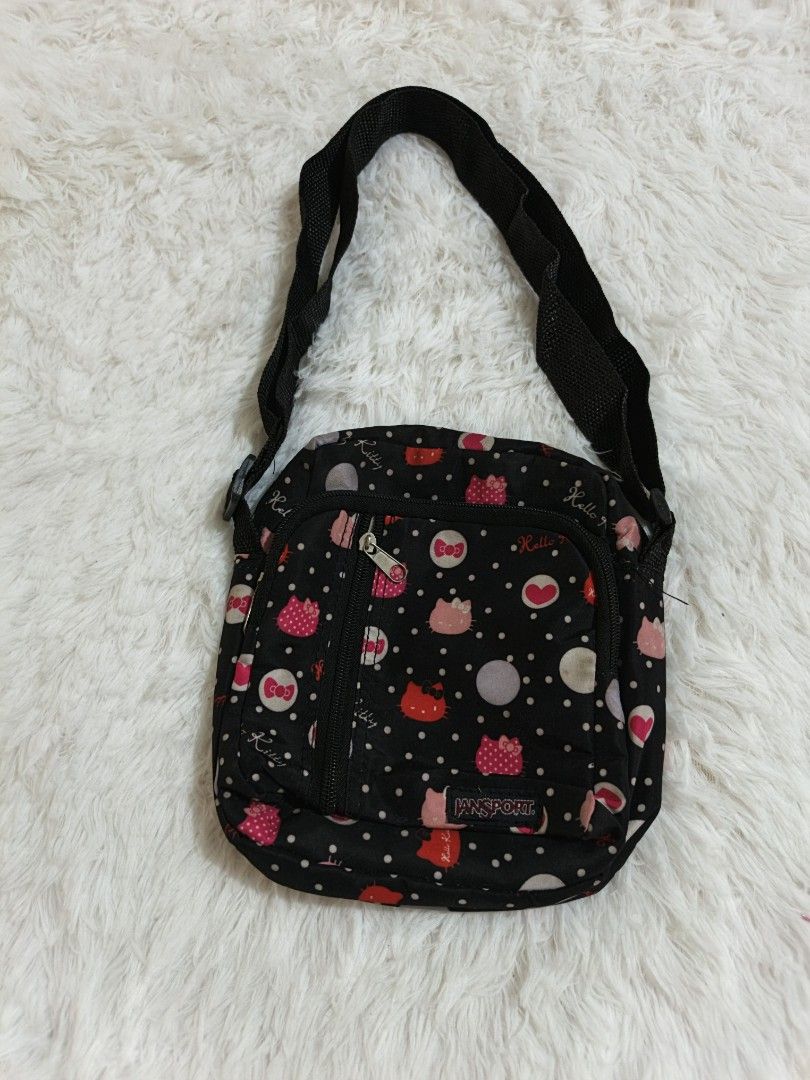 Jansport Hello Kitty Crossbody Bag (Category: Cross-body Bags) located in Marikina City. Submitted by andreah_16 (Listing ID 1437640838, Image 1). Description: - Jansport crossbody bag - Black base with Kitty and polka dot pattern - Front zippered pocket - Main compartment - Adjustable black strap - Approximately 8 inches wide.