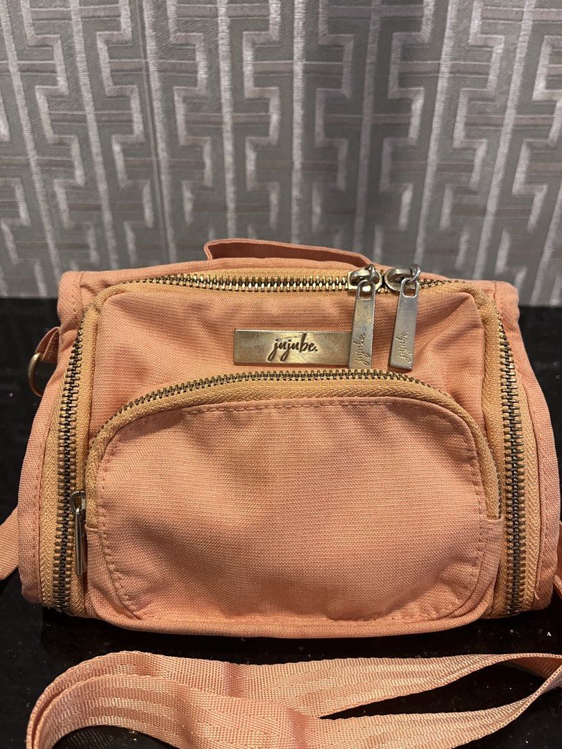 JuJuBe Mini BFF Crossbody Bag (Category: Cross-body Bags) located in Pasig City. Submitted by jackiedla (Listing ID 1437654763, Image 1). Description: - JuJuBe Mini BFF crossbody bag - Color: Be Peacjy - Features: - Front pocket - Multiple zippered compartments - Adjustable strap - JuJuBe logo on front.