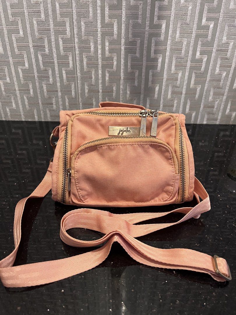 JuJuBe Mini BFF Crossbody Bag (Category: Cross-body Bags) located in Pasig City. Submitted by jackiedla (Listing ID 1437654763, Image 2). Description: - JuJuBe Mini BFF crossbody bag - Color: Be Peacjy - Features: - Front pocket - Multiple zippered compartments - Adjustable strap - JuJuBe logo on front.