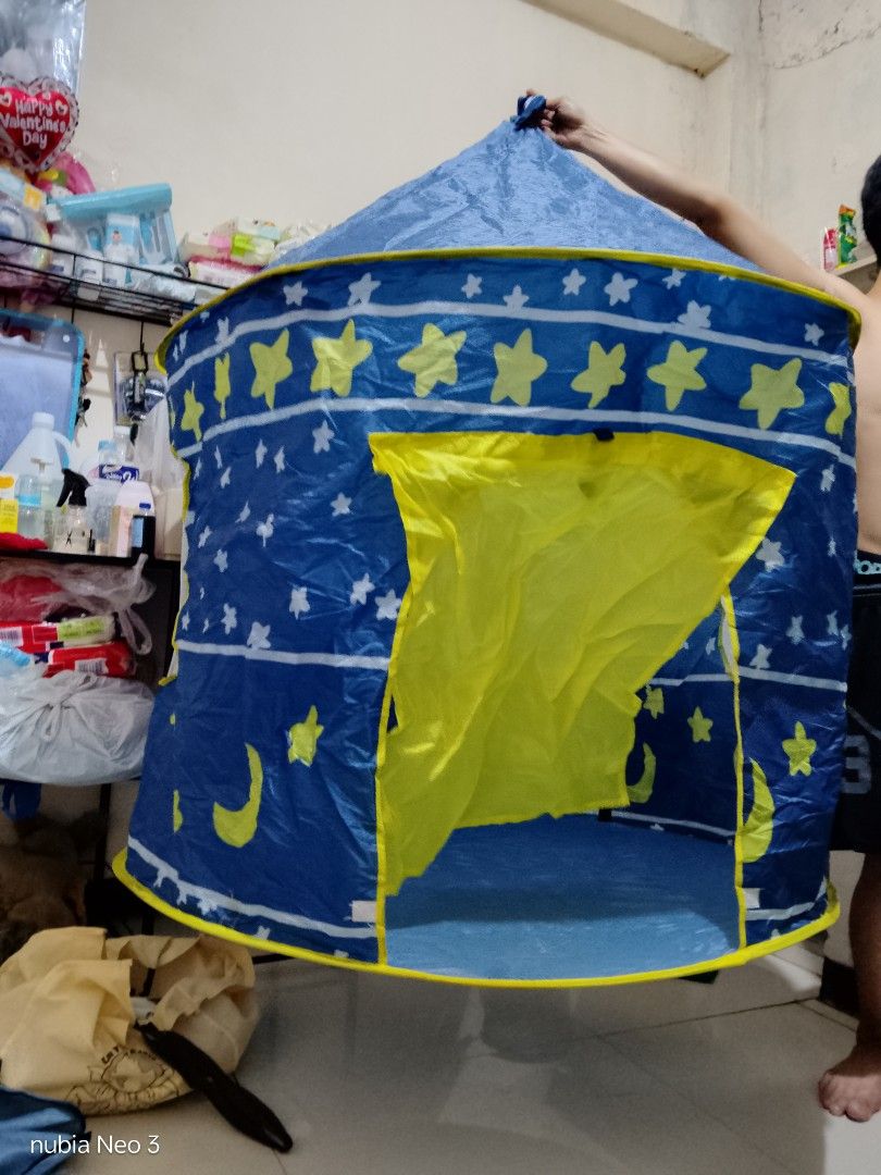 Kids Play Tent - Blue (Category: Infant Playtime) located in Manila. Submitted by beverlypastoral (Listing ID 1437738619, Image 3). Description: - Blue play tent with yellow stars and crescent moon design - Features a yellow door and windows - Includes poles for easy assembly - Simple to set up and take down - Ideal for indoor and outdoor fun.