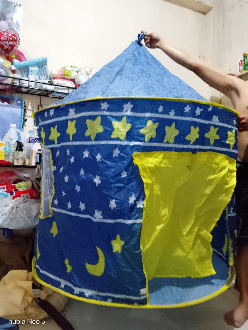 Kids Play Tent - Blue (Category: Infant Playtime) located in Manila. Submitted by beverlypastoral (Listing ID 1437738619, Image 2). Description: - Blue play tent with yellow stars and crescent moon design - Features a yellow door and windows - Includes poles for easy assembly - Simple to set up and take down - Ideal for indoor and outdoor fun.