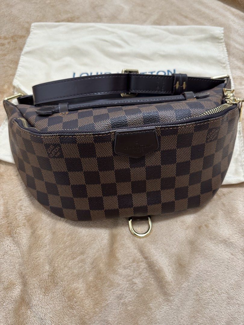 Louis Vuitton Damier Ebene Bumbag (Category: Luxury Bags & Wallets) located in Manila. Submitted by savilaaa (Listing ID 1437692060, Image 1). Description: - Preloved Louis Vuitton Bumbag - Product Code - Damier Ebene canvas - Gold-tone hardware - Adjustable brown leather strap - Includes dust bag - Classic checkerboard pattern - Features Louis Vuitton logo patch.