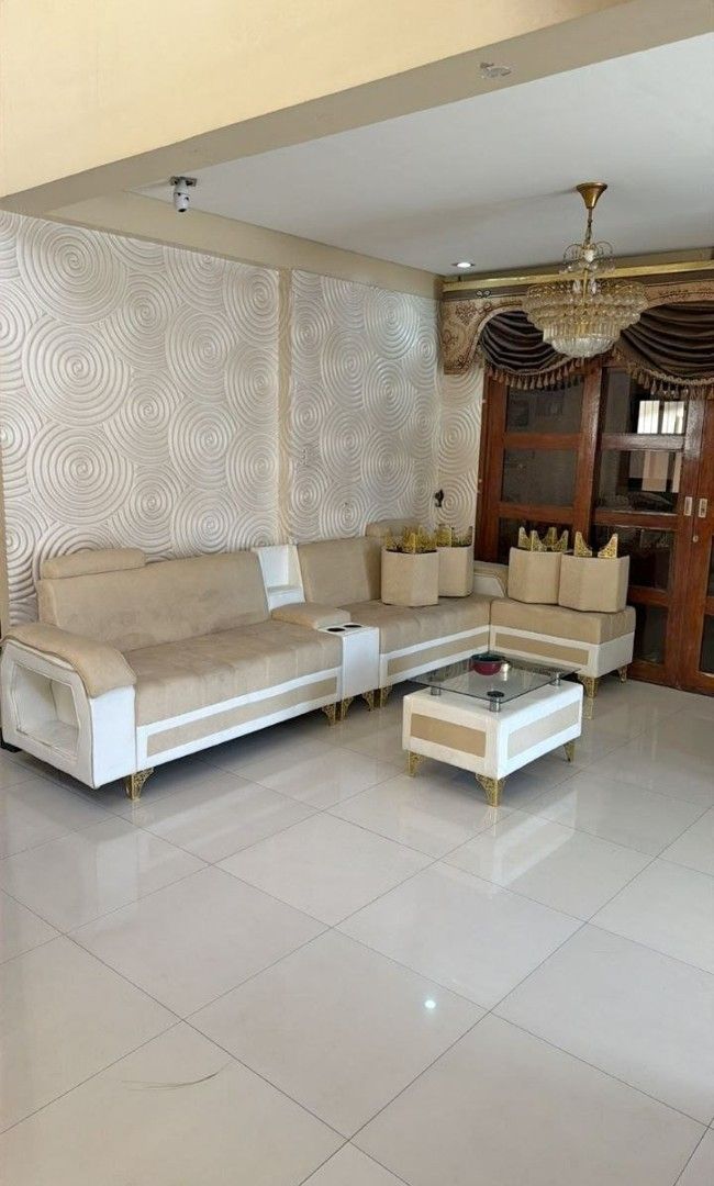 L-Shaped Sofa Set with Coffee Table (Category: Sofas) located in Pasay City. Submitted by vonneq (Listing ID 1437622490, Image 1). Description: - L-shaped sofa set with matching coffee table - Features a neutral color palette (beige and white) - Coffee table has a glass top - Well-maintained condition - Includes a three-seater sofa - Adds sophistication to any living space.