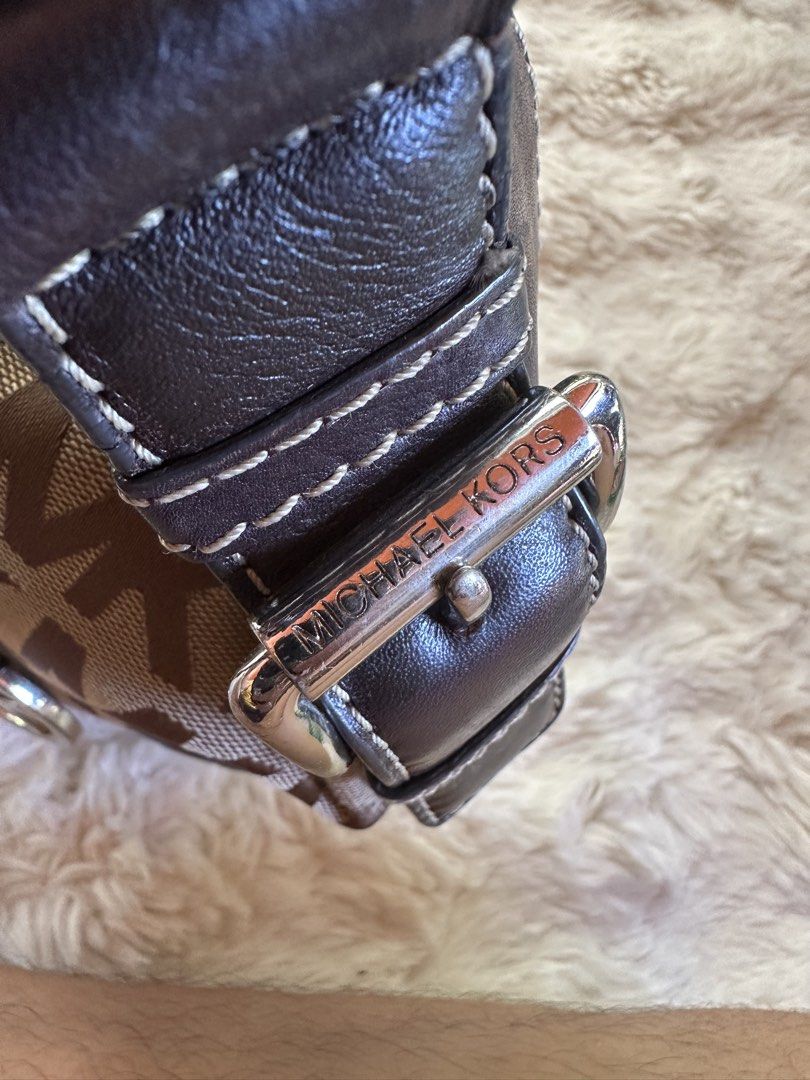 Michael Kors Shoulder Bag (Category: Luxury Bags & Wallets) located in Digos. Submitted by venusacaro13427 (Listing ID 1437591050, Image 3). Description: - Authentic Michael Kors shoulder bag - Iconic MK logo print - Stylish curved design - Brown leather accents - Matching shoulder strap - Branded interior lining - Interior zippered pocket - Silver-tone hardware - Includes Michael Kors logo charm.