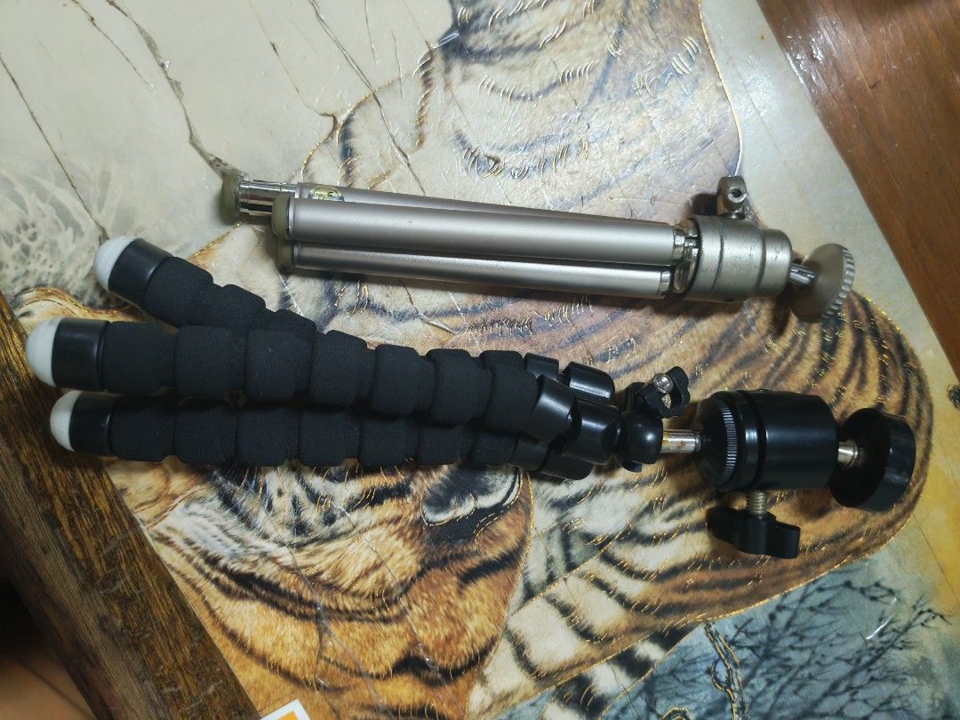 Mini Tripod Set buy 1 take 1 metal (Category: Tripods & Monopods) located in Manila. Submitted by GentleGiant (Listing ID 1437676150, Image 2). Description: - Two mini tripods included - Silver tripod: adjustable legs, ball head - Black tripod: flexible, foam-covered legs, ball head - Designed for small cameras and phones - Compact and ideal for tabletop use.
