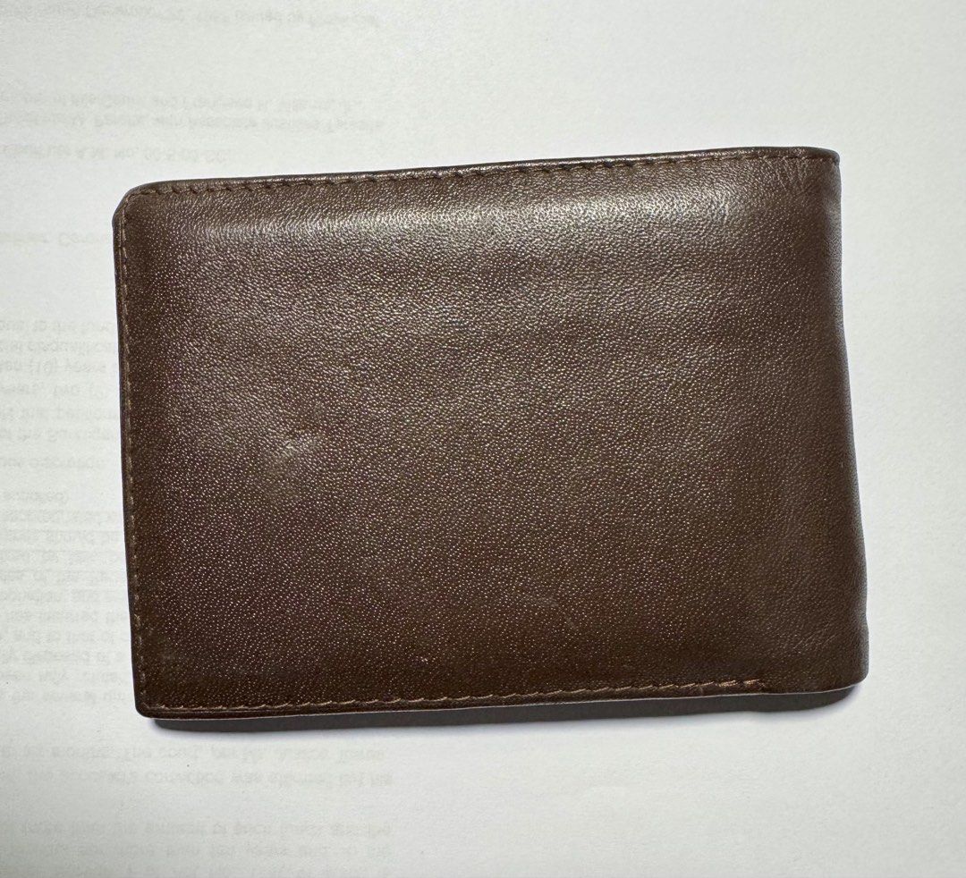 MJIM Classic Brown Leather Wallet (Category: Wallets & Card holders) located in Makati City. Submitted by ja_declutters (Listing ID 1437607798, Image 3). Description: - Genuine brown leather wallet - Classic bi-fold design - Features multiple card slots - Includes a clear ID window - Adorned with the MJIM Classic logo - Light-colored interior lining - AUTHENTIC/ORIGINAL.