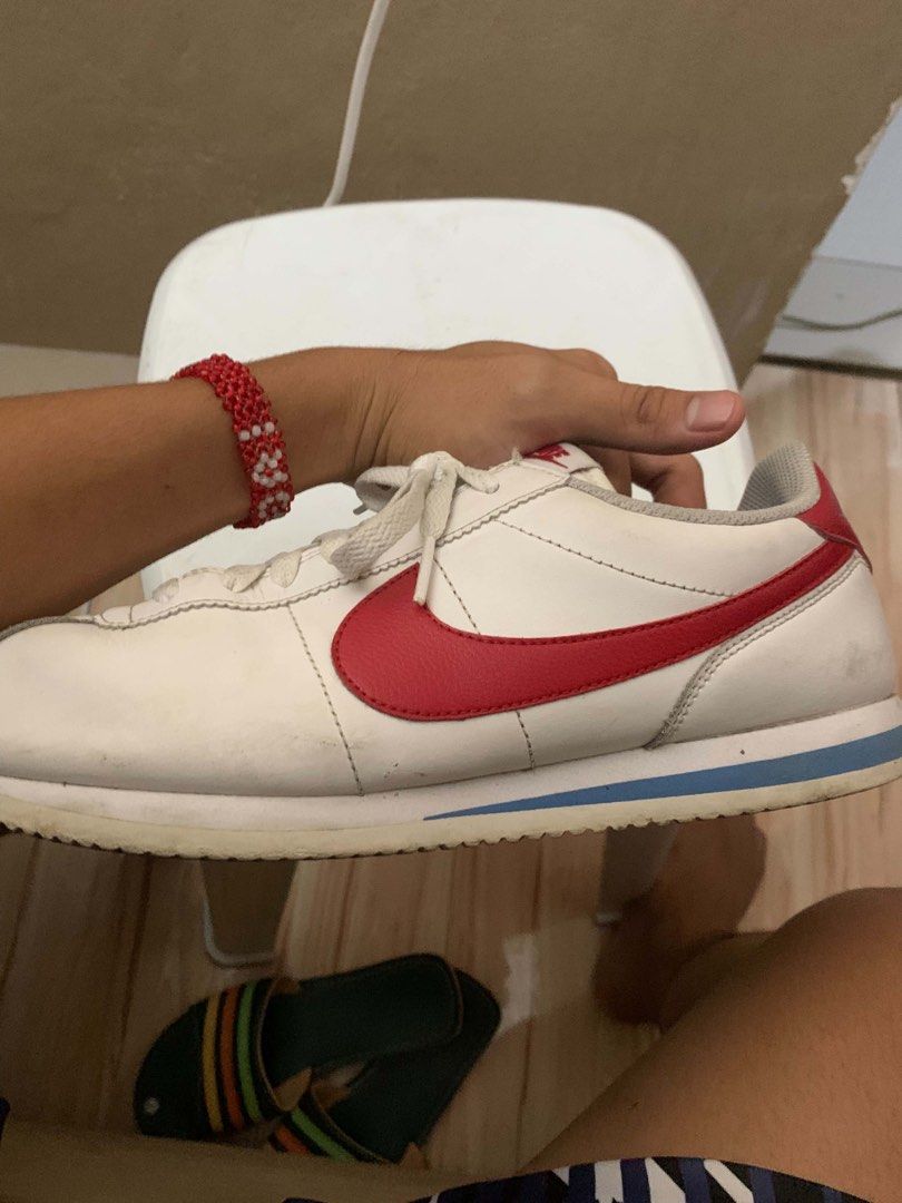 Nike Cortez White Red Sneakers (Category: Sneakers) located in Manila. Submitted by kimsanorjo03985 (Listing ID 1437630473, Image 2). Description: - Classic Nike Cortez - White with red accents - Iconic Nike swoosh - Nike logo on heel - White laces - Blue stripe on sole.