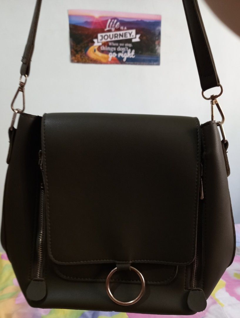 Olive Green Shoulder Bag/Knapsack with Zippers (Category: Shoulder Bags) located in Mandaluyong City. Submitted by gantan.tree (Listing ID 1437634940, Image 1). Description: Please read WHOLE ad thoroughly! Olive green shoulder bag -Size: height 10" width 11" sides 3"-3.5" base: 8.25" - Zippered main compartment - Flap closure w/ ring detail - 2 front zippered pockets - Leather like material - adjustable knapsack strap length: 27" *Check pictures