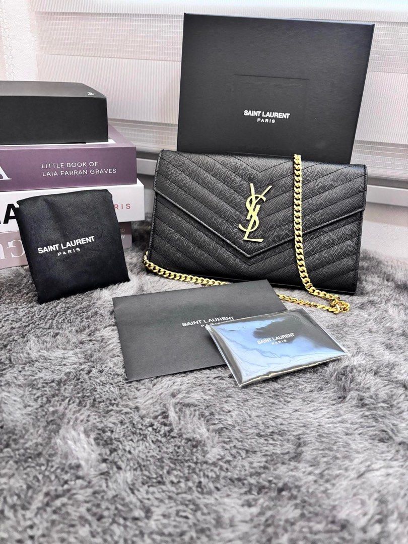 Original YSL Cassandre Envelope Chain Wallet WOC in Large Grained Leather (Category: Luxury Bags & Wallets) located in Manila. Submitted by shopwithbrilliantadel (Listing ID 1437749944, Image 1). Description: Good Condition Guaranteed authentic or your money back Complete Set with Receipt, no paperbag With authenticity certificate from Koibito Korea .