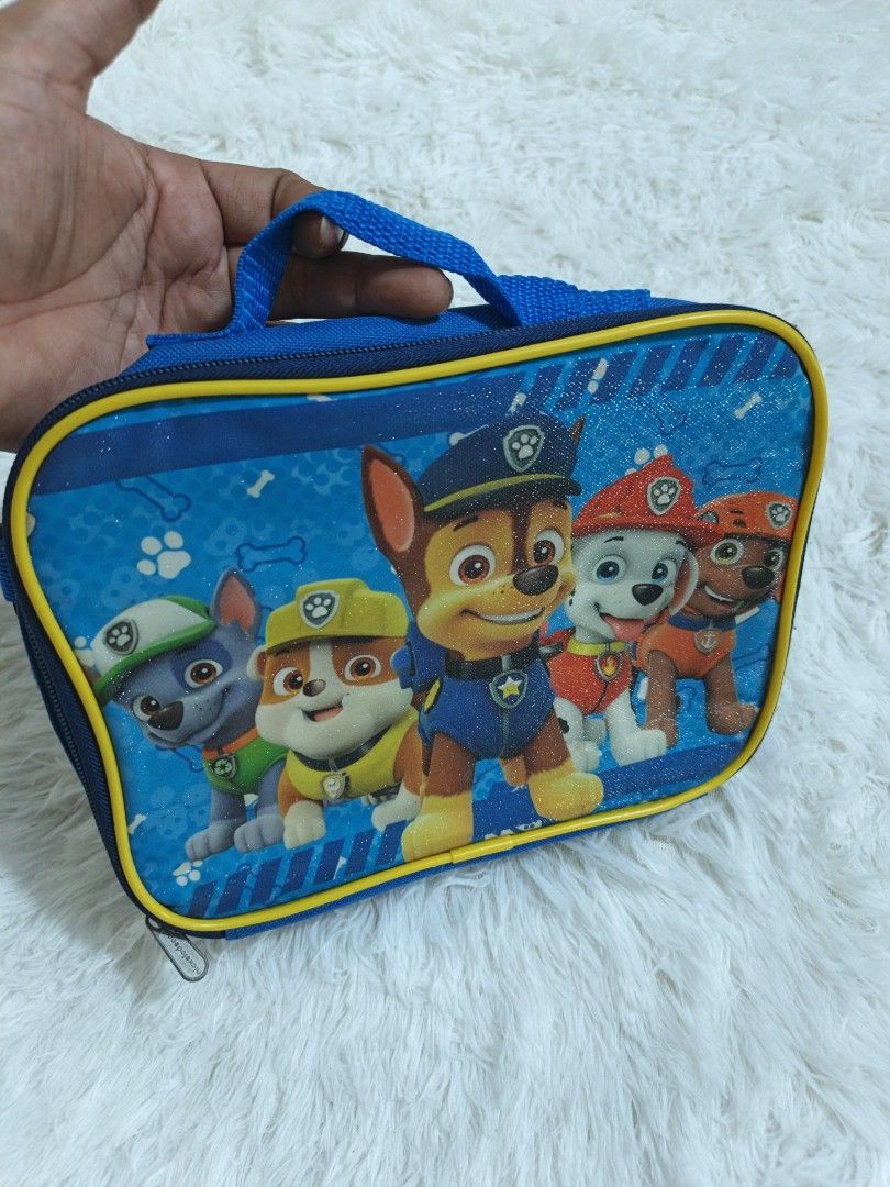 Paw Patrol Lunch Bag (Category: Other Babies Going Out Needs) located in Marikina City. Submitted by andreah_16 (Listing ID 1437610746, Image 2). Description: - Paw Patrol lunch bag - Features a vibrant Paw Patrol design - Blue exterior with yellow trim - Convenient handle for carrying - Insulated interior to keep food fresh - Official Nickelodeon product (2018) - Made in China.