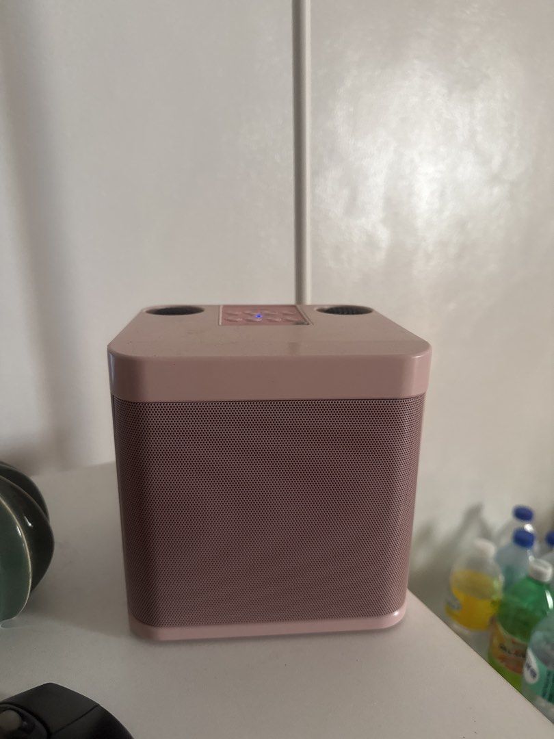 Pink Speaker with Wireless Microphones (Category: Soundbars, Speakers & Amplifiers) located in Calamba. Submitted by leeadriannn796 (Listing ID 1437588871, Image 1). Description: - Pink speaker with a square design and mesh front - Includes two wireless pink microphones - Features cup holders and control buttons on top - Ideal for karaoke and small gatherings.