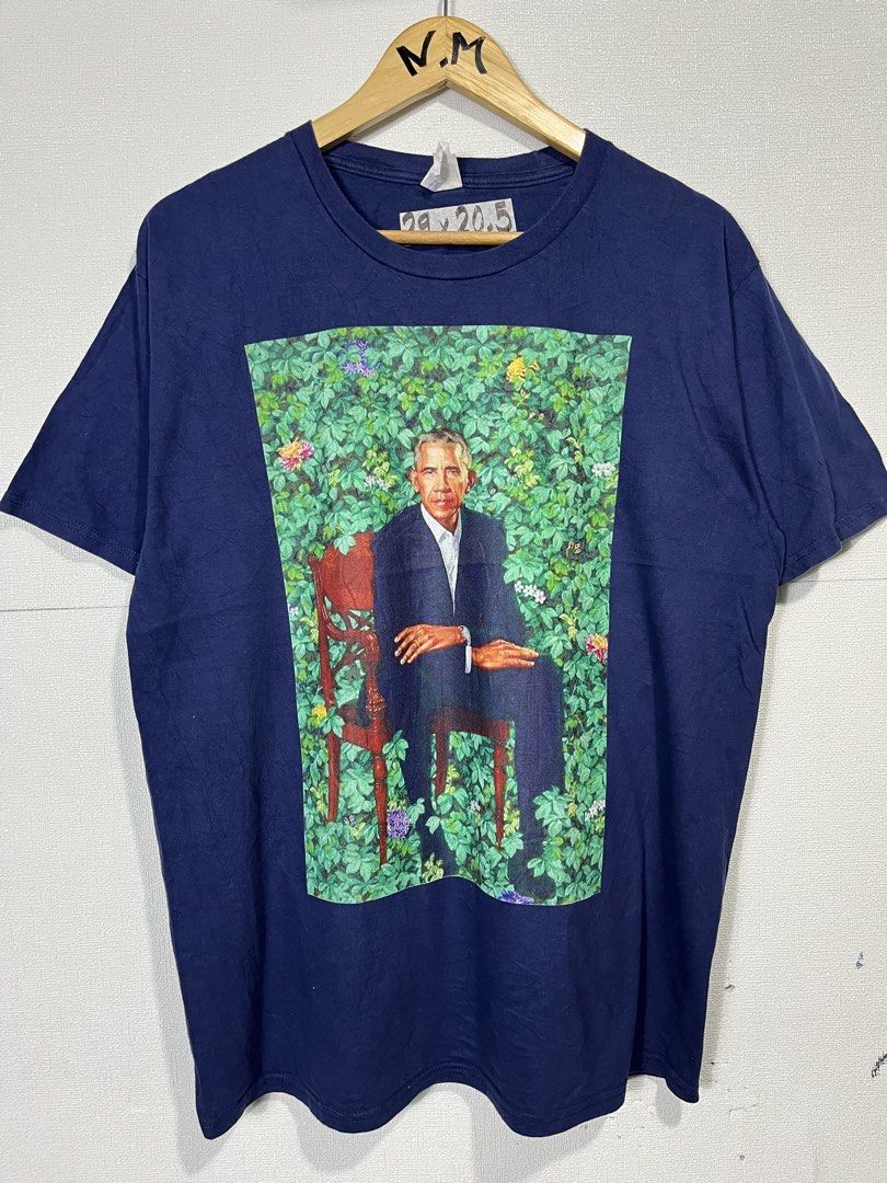 Port & Company Obama Graphic Tee - Large (Category: Tshirts & Polo Shirts ) located in Baguio. Submitted by cosmicgem_21b525 (Listing ID 1437710930, Image 1). Description: - Navy blue t-shirt - Size: Large - Brand: Port & Company - Graphic: Barack Obama seated on a chair with foliage - Style: Crew neck, short sleeves - Material: Cotton.