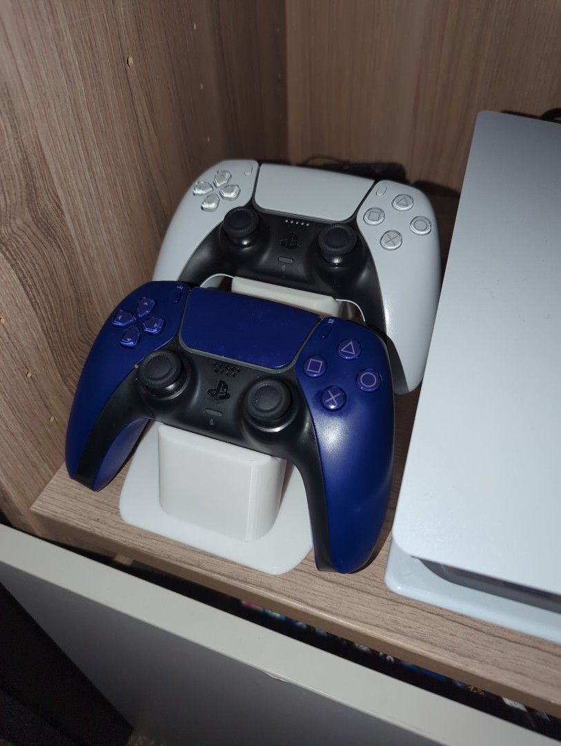 PS5 Controller Stand (Category: Controllers) located in Singapore. Submitted by abc1234xyz (Listing ID 1437705682, Image 2). Description: - Stand for PS5 controllers - Holds two controllers - Black / Grey / White / Yellow / Red / Blue / Green - Keeps controllers organized and charged.