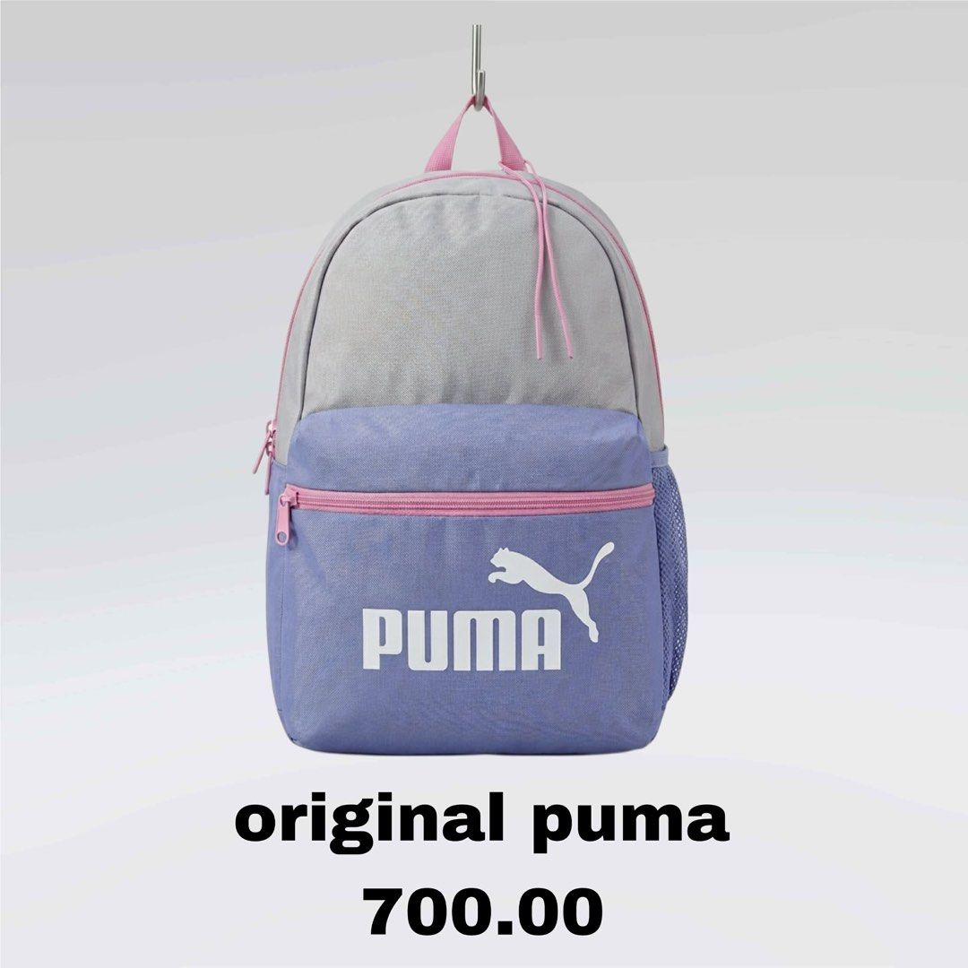 Puma Backpack (Category: Backpacks) located in Manila. Submitted by dethbalde01295 (Listing ID 1437662528, Image 1). Description: Original Puma backpack with a two-tone design. Features a gray top and a blue front with a pink zipper and accents. Includes the Puma logo on the front. The backpack has a mesh side pocket. Perfect for everyday use..