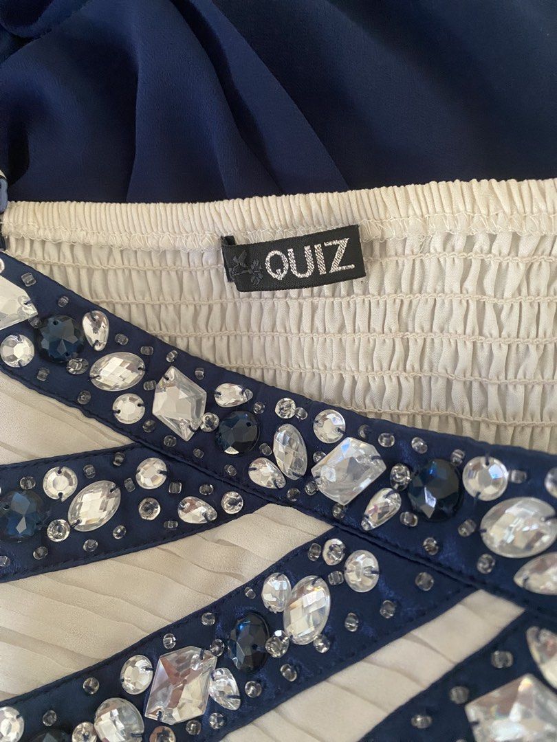 Quiz Embellished Dress (Category: Dresses) located in Gapan. Submitted by sonikku (Listing ID 1437683163, Image 3). Description: - Quiz mini dress - Navy blue skirt - Cream-colored bodice with embellished detailing - Comes with removable straps - Structured bodice with sparkling accents - Mini length - Size: GB8 / EU36 - Perfect for special occasions.