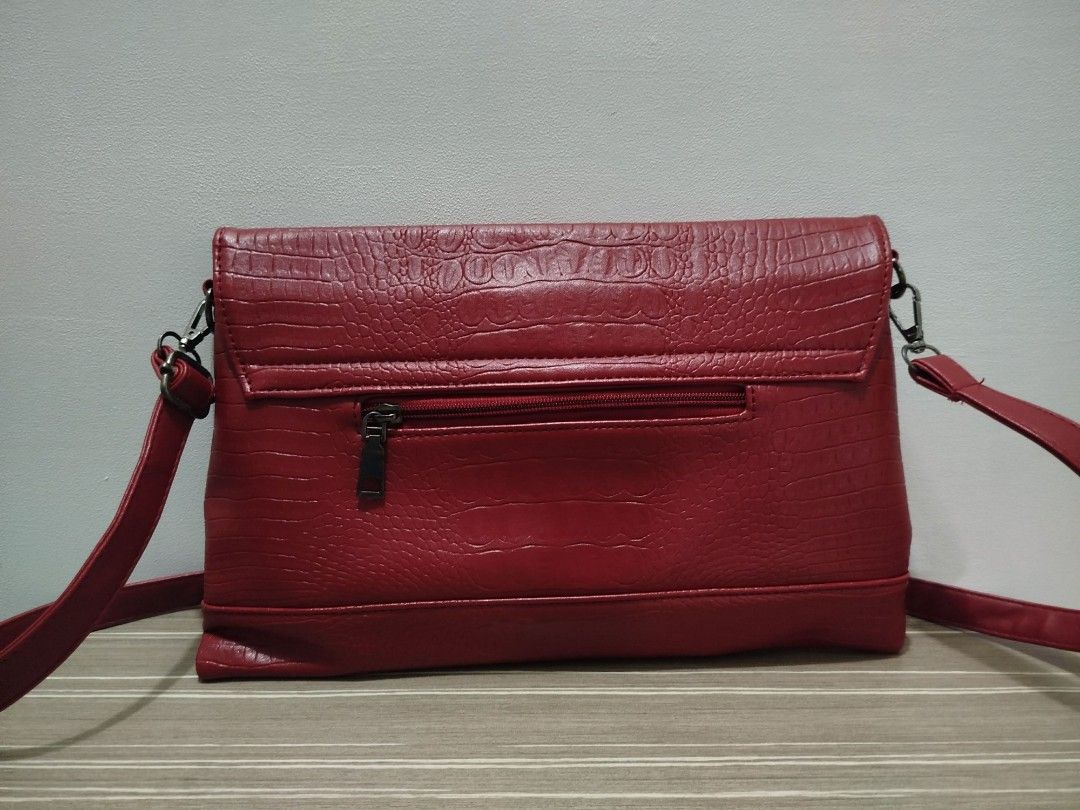 Red Crocodile Embossed Large Crossbody Bag (Category: Cross-body Bags) located in Cavite. Submitted by prncs.jc (Listing ID 1437715186, Image 2). Description: Product Description: - Item: Red Crocodile Embossed Large Crossbody Bag - Color: Crimson Red - Material: Crocodile Skin / Embossed Leather - Closure: Front flap with a bold black trapezoidal magnetic buckle - Handle/Strap: Long, adjustable matching red leather crossbody strap with silver-to