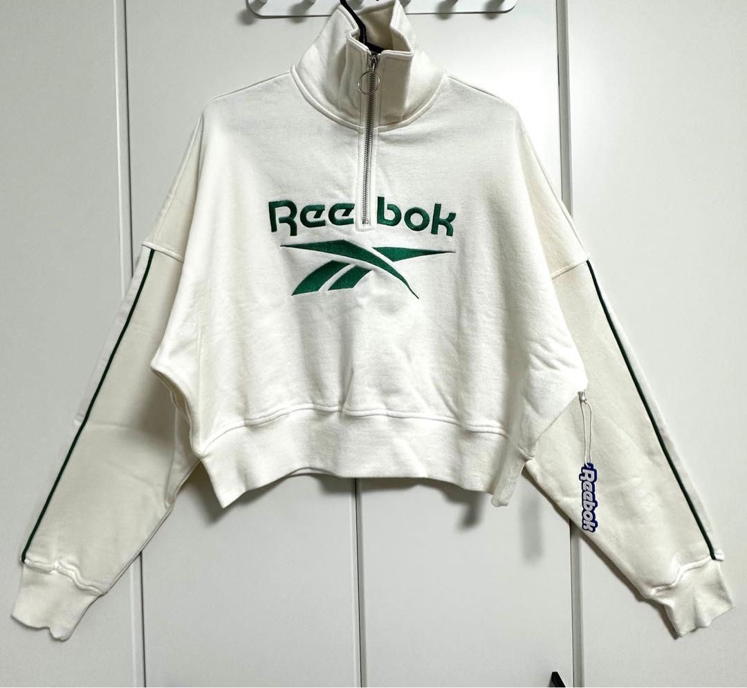 Reebok x Forever 21 Cropped Sweatshirt (Category: Longsleeves) located in Pasay City. Submitted by drogon234 (Listing ID 1437752723, Image 1). Description: - Reebok cropped sweatshirt - White color - Green Reebok logo on front - Green stripes on sleeves - High neck with zipper - Ribbed cuffs - Reebok tag on sleeve.