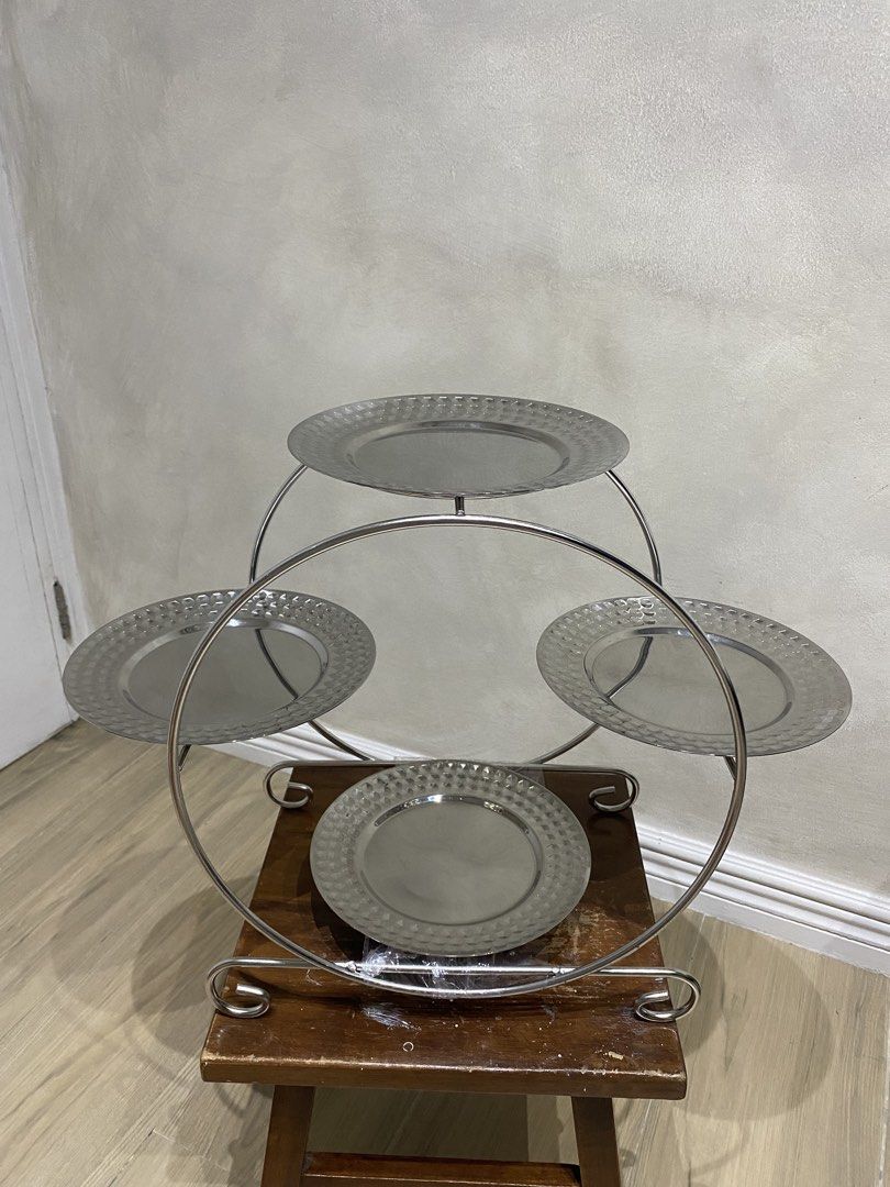 Rossetti 4-Tier Silver Dessert Tray (Category: Other Kitchenware & Tableware) located in Manila. Submitted by papupeeps (Listing ID 1437649414, Image 1). Description: Modern Design: The minimalist, geometric metal frame provides a contemporary look that complements any decor. Textured Plates: Each of the four tiers features a classic hammered metal pattern, adding a touch of sophisticated detail and helping to hide minor scratches or fingerprints