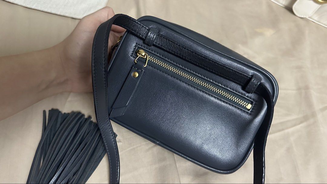 Saint Laurent Lou Camera belt Bag (Category: Luxury Bags & Wallets) located in Quezon City. Submitted by mema0522 (Listing ID 1437603589, Image 3). Description: - Authentic Saint Laurent Lou Camera Bag - Dark blue color - Quilted design - Gold YSL logo - Detachable tassel - Crossbody strap - Includes dust bag, tags, and Saint Laurent pouch - Zip closure - Compact design Flaws on the glazing, I tried to DIY it kasi need ko na gamitin next day pero