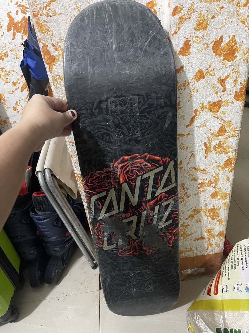 Santa Cruz Skateboard (Category: Skates, Rollerblades & Scooters) located in Dasmarinas. Submitted by curruptdot (Listing ID 1437593710, Image 2). Description: - Santa Cruz skateboard - Features a skull graphic on the deck - Rose design with Santa Cruz logo on the underside - Classic skateboard shape - Grip tape is present - DECK ONLY.