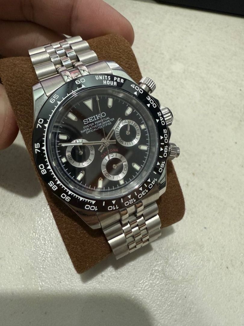Seiko Mod Daytona Watch (Category: Luxury Watches) located in Manila. Submitted by pael92 (Listing ID 1437746737, Image 2). Description: - Seiko Daytona-inspired design - Black dial with silver sub-dials - Stainless steel bracelet - Tachymeter bezel - Chronograph functions - Date display at 6 o'clock - Presented on a watch pillow.