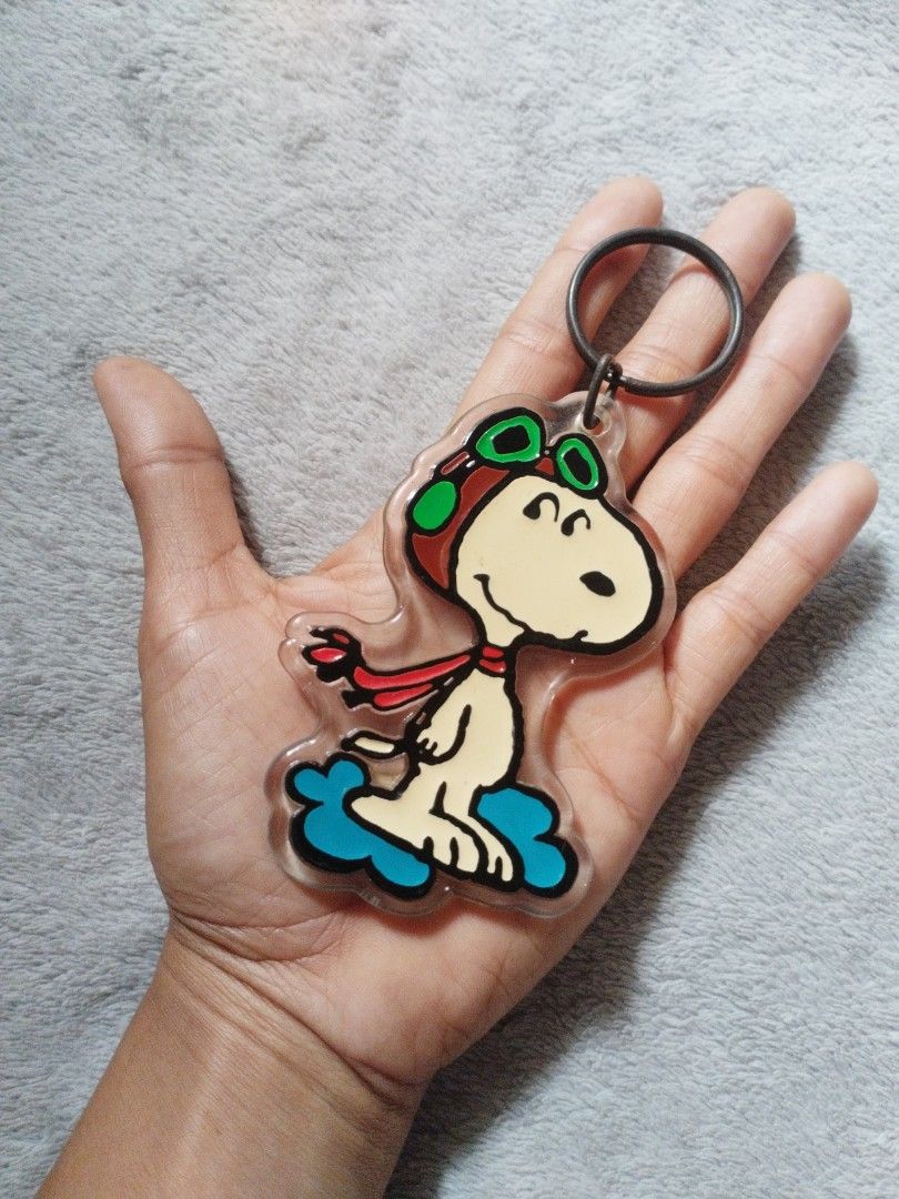 Snoopy Keychain (Category: Toys & Games) located in Davao. Submitted by mengsmixitems (Listing ID 1437639775, Image 3). Description: - Snoopy aviator keychain - Clear acrylic design - Metal keyring - Shaped like Snoopy on a cloud - Great accessory for keys or bags.