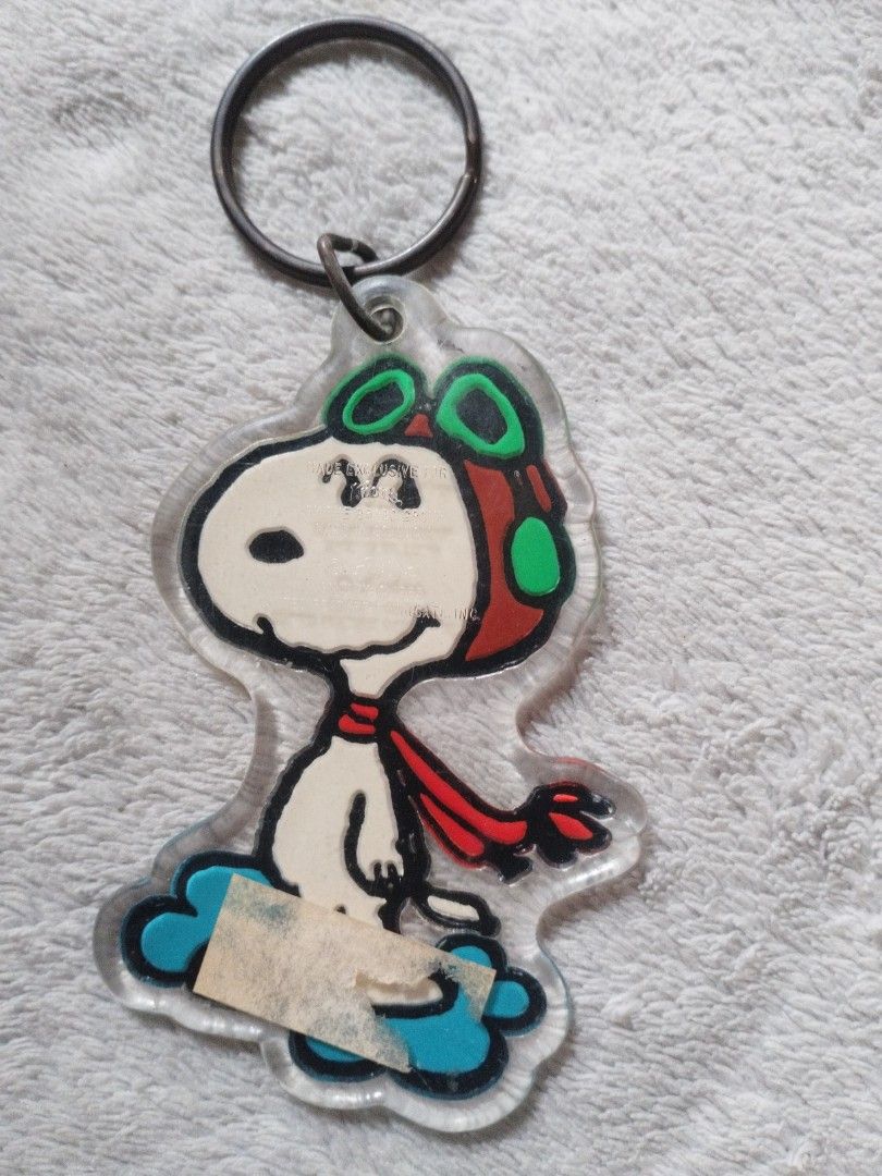 Snoopy Keychain (Category: Toys & Games) located in Davao. Submitted by mengsmixitems (Listing ID 1437639775, Image 2). Description: - Snoopy aviator keychain - Clear acrylic design - Metal keyring - Shaped like Snoopy on a cloud - Great accessory for keys or bags.