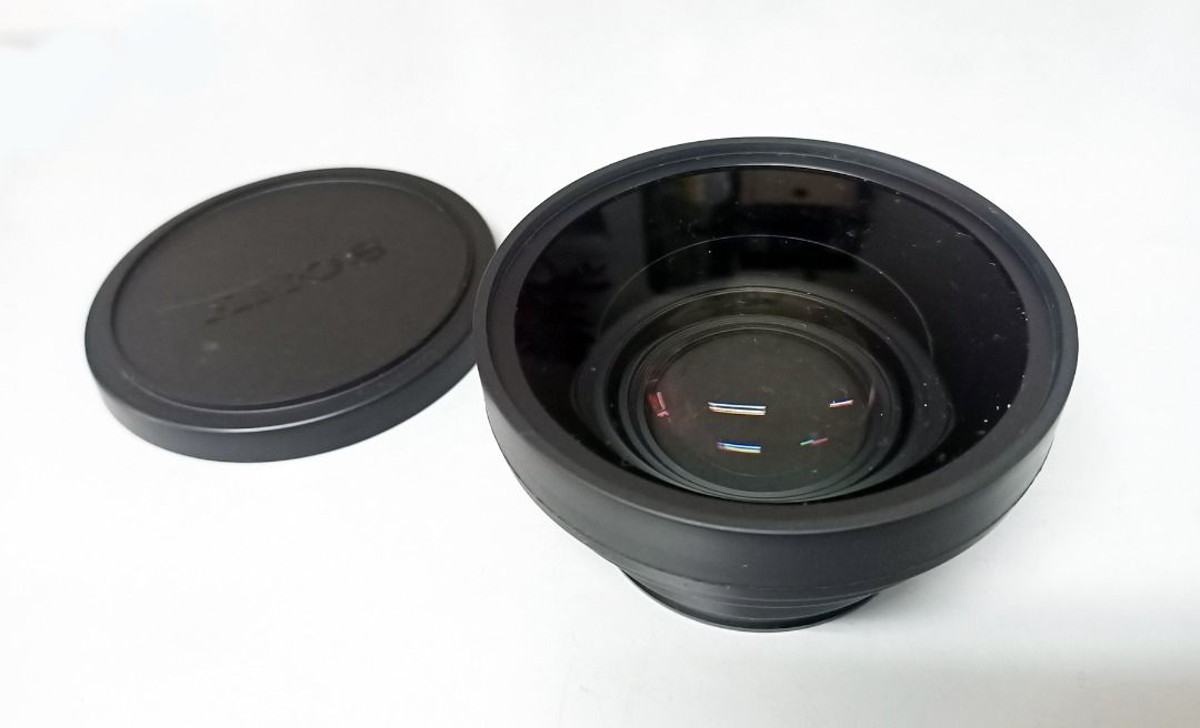 SONY WIDE LENS FOR DCR-VX2000 CAMERA WITH POUCH Pouch (Category: Video Cameras) located in Pasig City. Submitted by prosmmad (Listing ID 1437643464, Image 2). Description: - Sony Wide Lens for Digital Handycam DCR-VX2000 - Includes lens cap with Sony Logo - Comes with a protective drawstring pouch - Sleek black design.