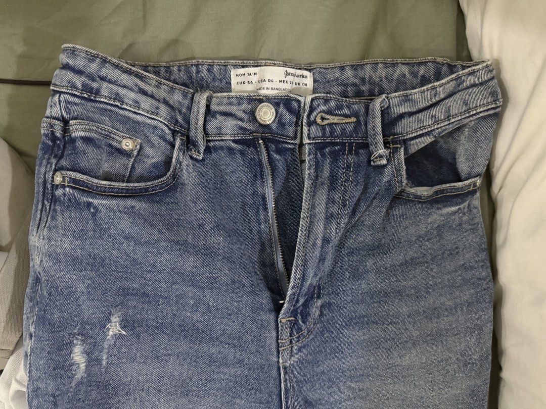 Stradivarius Mom Slim Jeans (Category: Jeans) located in Makati City. Submitted by definehipster (Listing ID 1437749647, Image 1). Description: - Stradivarius Mom Slim jeans - Light blue wash - Distressed detail - Button and zipper closure - Size: EUR 34, US 06, MEX 06.
