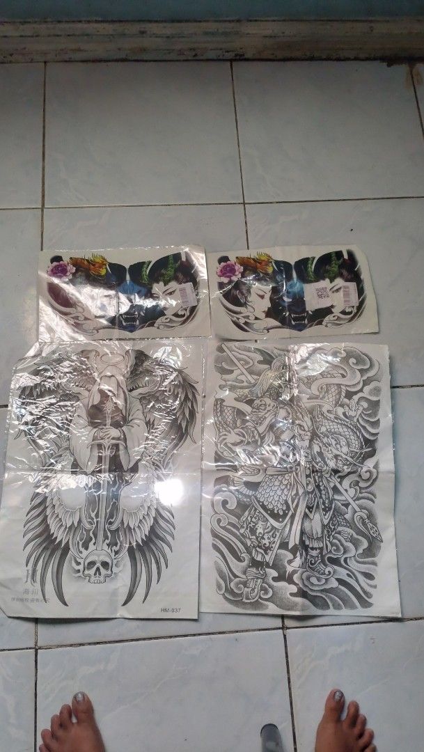 Temporary Tattoo Designs - Assorted Styles set (Category: Art & Prints) located in Valenzuela. Submitted by diane.35 (Listing ID 1437641313, Image 1). Description: - Set of temporary tattoo sheets. - Features various designs including geishas, dragons, and angels. - Detailed black and white artwork. - Each sheet is individually packaged. - Great for themed events or trying out tattoo designs..