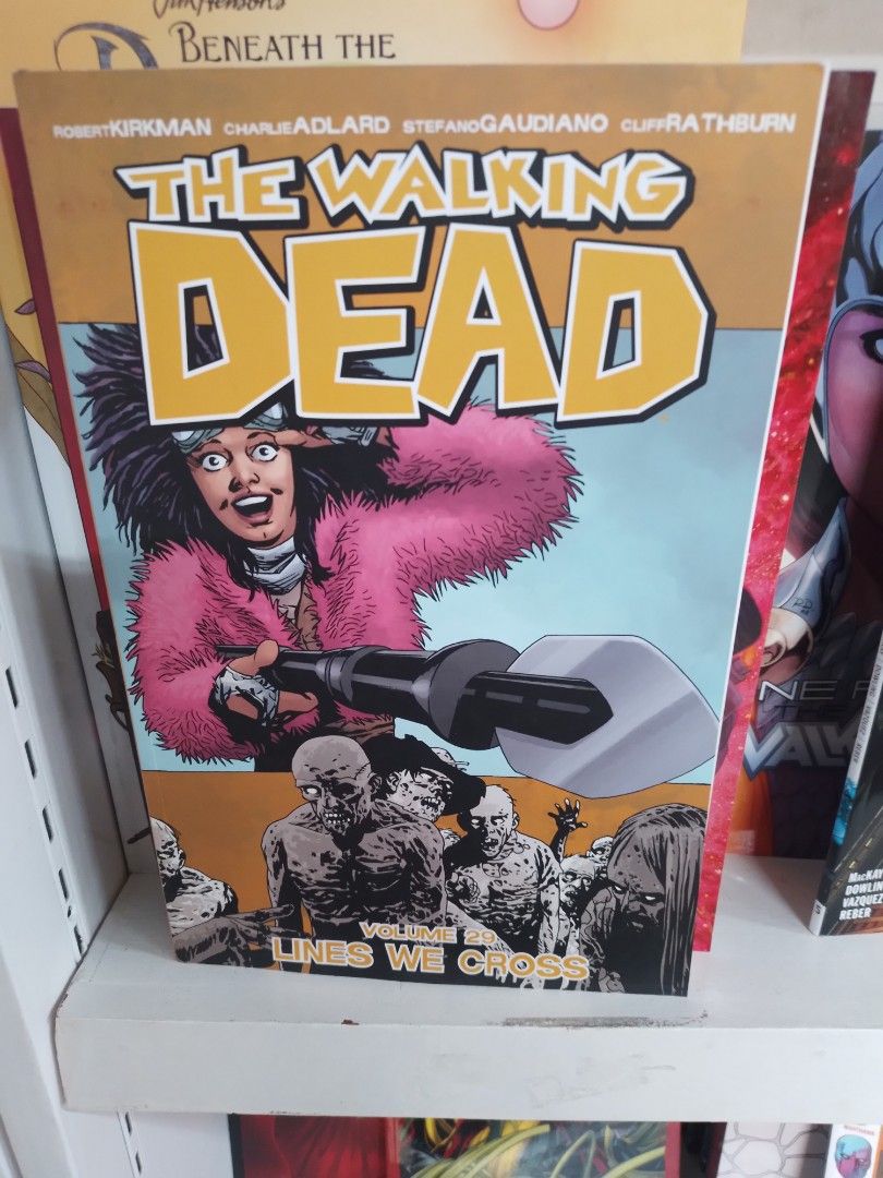 The Walking Dead: Lines We Cross (Category: Comics & Manga) located in Caloocan City. Submitted by teacherjen53235 (Listing ID 1437662383, Image 1). Description: - The Walking Dead: Lines We Cross graphic novel. - Cover art features a character with a pink fur coat and a weapon. - Back of the book details the world's end and the zombie apocalypse. - A must-have for Walking Dead fans..