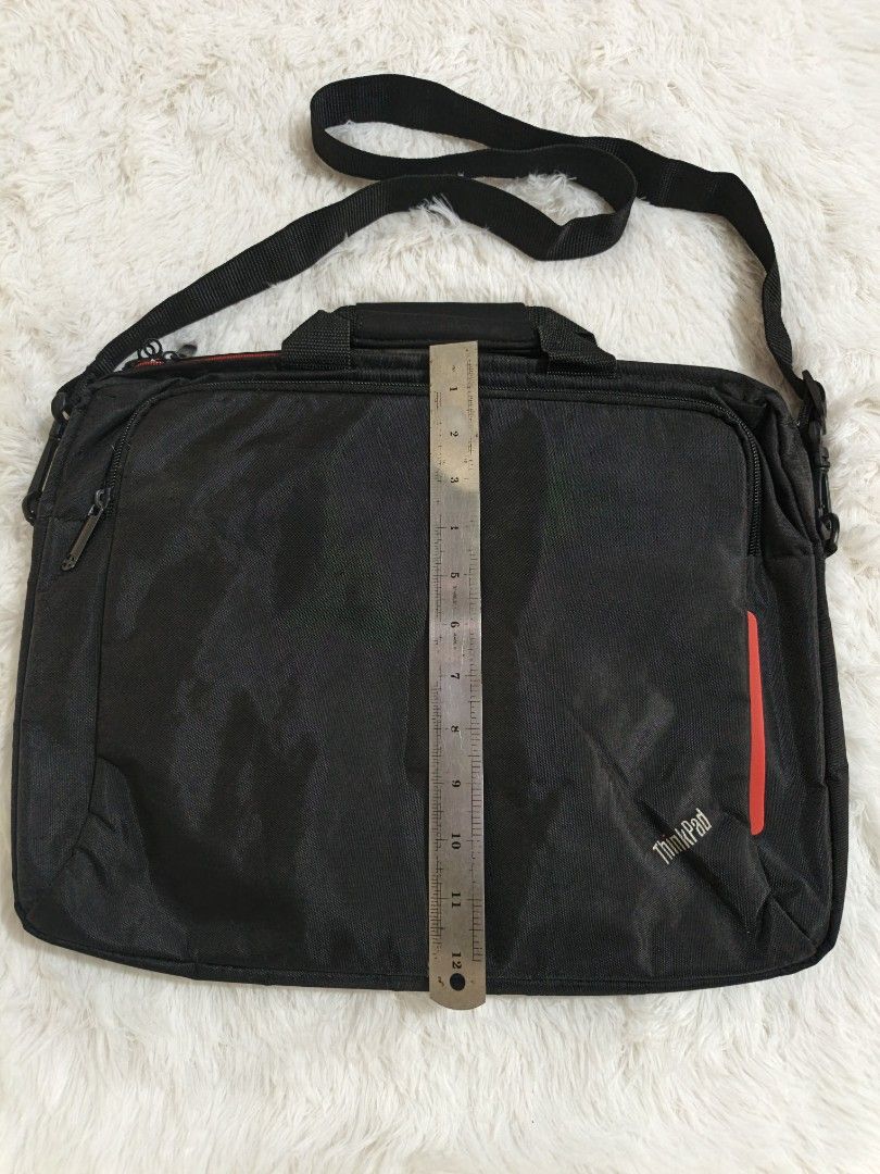 ThinkPad Laptop Bag with Shoulder Strap (Category: Laptop Bags & Sleeves) located in Marikina City. Submitted by andreah_16 (Listing ID 1437600498, Image 3). Description: - Black ThinkPad laptop bag - Red accent stripe - Shoulder strap and top handle - Zippered main compartment with red lining - Designed for laptop and accessories - ThinkPad logo on front.