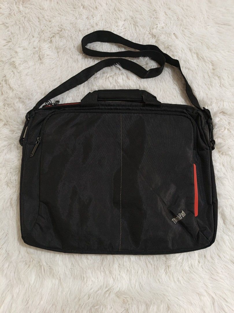 ThinkPad Laptop Bag with Shoulder Strap (Category: Laptop Bags & Sleeves) located in Marikina City. Submitted by andreah_16 (Listing ID 1437600498, Image 1). Description: - Black ThinkPad laptop bag - Red accent stripe - Shoulder strap and top handle - Zippered main compartment with red lining - Designed for laptop and accessories - ThinkPad logo on front.