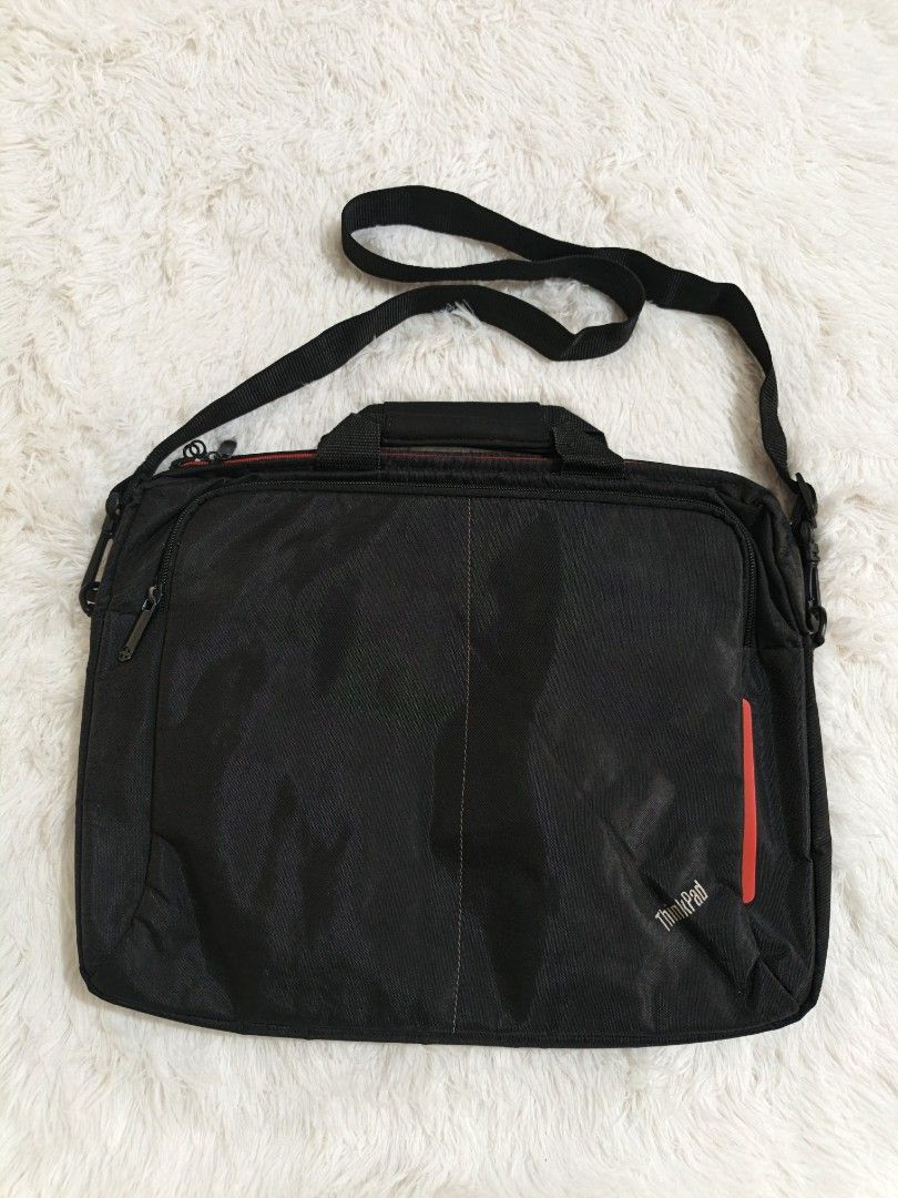 ThinkPad Laptop Bag with Shoulder Strap (Category: Laptop Bags & Sleeves) located in Marikina City. Submitted by andreah_16 (Listing ID 1437600498, Image 2). Description: - Black ThinkPad laptop bag - Red accent stripe - Shoulder strap and top handle - Zippered main compartment with red lining - Designed for laptop and accessories - ThinkPad logo on front.