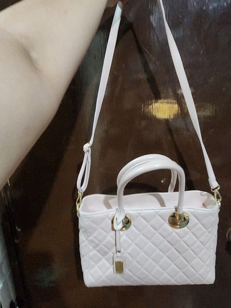 Trussardi Quilted Handbag (Category: Luxury Bags & Wallets) located in Makati City. Submitted by itsgonnabemay (Listing ID 1437703713, Image 3). Description: Elegant Trussardi handbag in a quilted design. Can be a crossbody bag and hand bag. Features a light pink color with gold-tone hardware. Includes a top handle and a detachable shoulder strap. The bag has a rectangular shape with a flap closure. The Trussardi logo is visible on a small tag at