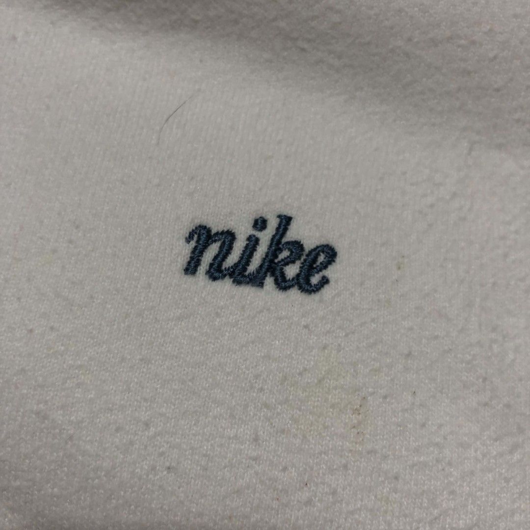 Vintage Nike V-Neck Sweatshirt (Category: Coats, Jackets and Outerwear) located in Cavite. Submitted by autothrift (Listing ID 1437604579, Image 3). Description: - White Nike V-neck sweatshirt - Small Nike logo on chest - Navy blue accents on collar and cuffs - Brand and size tag included - Classic and comfortable fit.