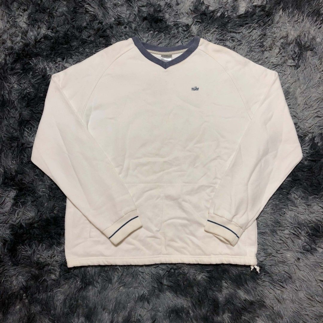 Vintage Nike V-Neck Sweatshirt (Category: Coats, Jackets and Outerwear) located in Cavite. Submitted by autothrift (Listing ID 1437604579, Image 1). Description: - White Nike V-neck sweatshirt - Small Nike logo on chest - Navy blue accents on collar and cuffs - Brand and size tag included - Classic and comfortable fit.