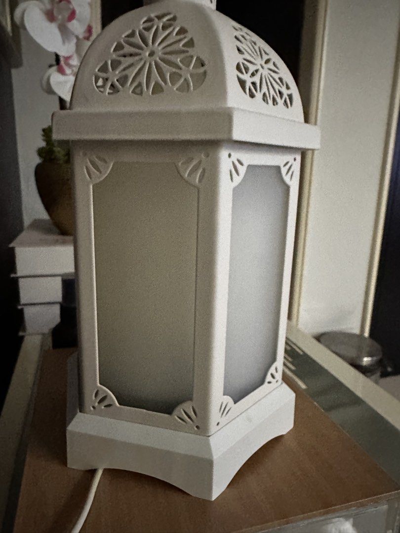 White Lantern Diffuser (Category: Other Home Decor) located in Seri Kembangan. Submitted by luxeforlessbysm (Listing ID 1437706602, Image 2). Description: - Elegant white lantern design - Decorative top and frosted panels - Includes power button and another button - Suitable for essential oils - Comes with a power cord - Perfect for adding style and fragrance to any room.