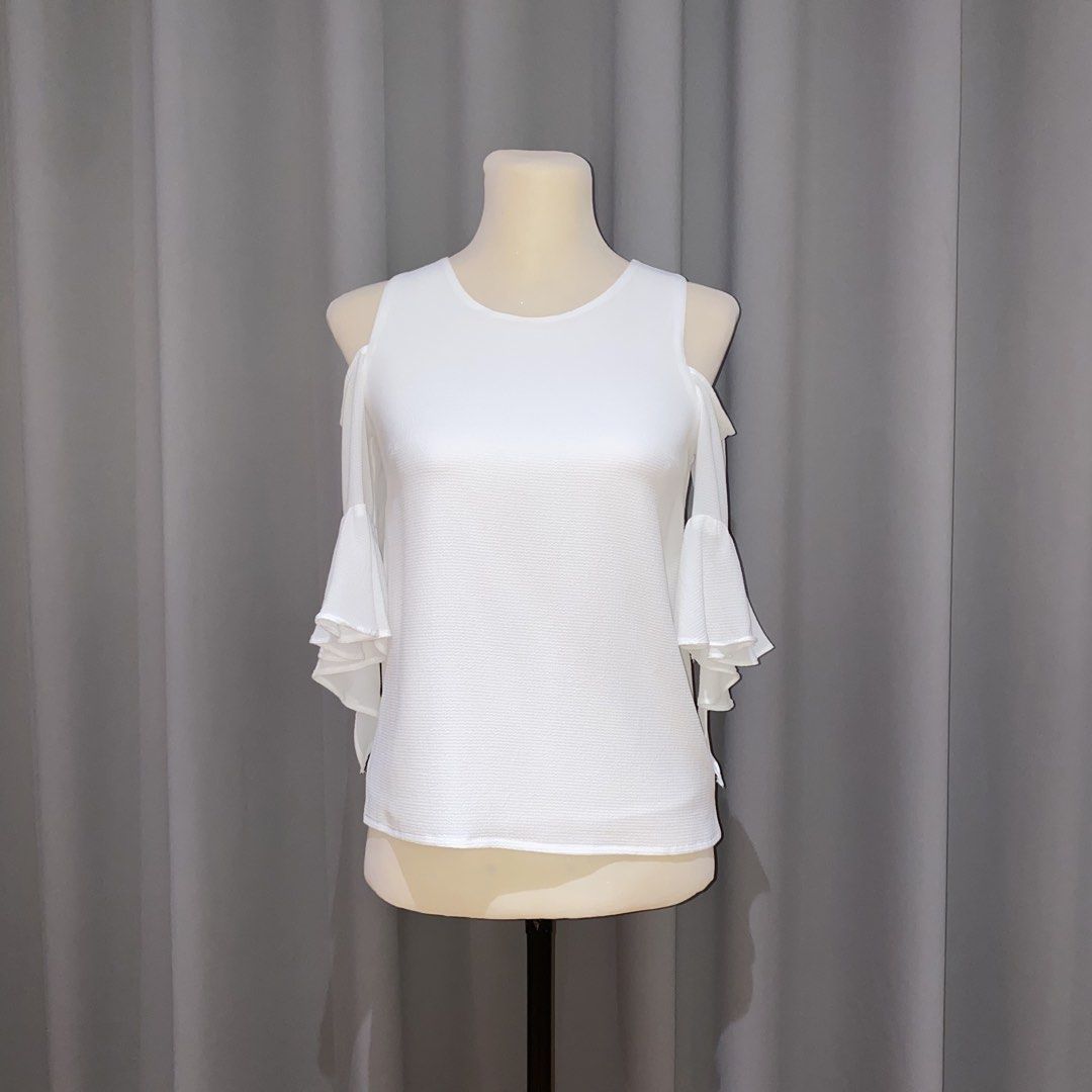 white cold shoulder ruffle top (Category: Blouses) located in Muntinlupa City. Submitted by declutterwithkk (Listing ID 1437676809, Image 1). Description: - white cold shoulder top - ruffled sleeves, round neckline - free size but best fits S.