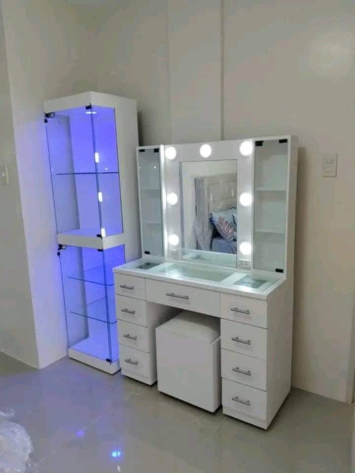 White Vanity Table with Lights and Stool (Category: Tables & Sets) located in Mabalacat. Submitted by joemamangun01 (Listing ID 1437597421, Image 2). Description: - White vanity table with built-in lights - Includes matching white stool - Multiple drawers and side shelves for storage - Sleek design with gold-colored handles - Ideal for makeup and skincare routines - Provides ample space for beauty essentials.