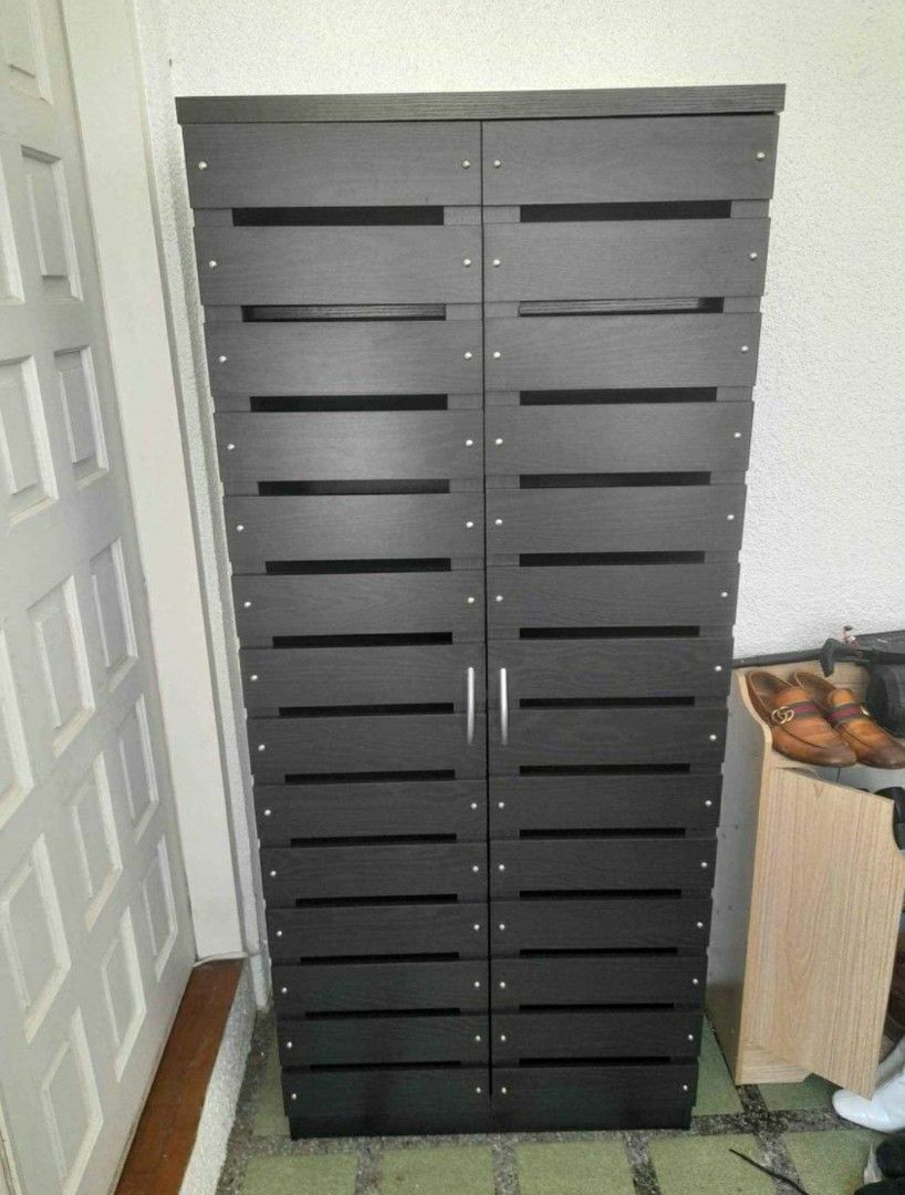 Wooden Shoe Cabinet with Multiple Shelves (Category: Shelves, Cabinets & Racks) located in Manila. Submitted by jerrymieborda05 (Listing ID 1437745781, Image 2). Description: - Stylish shoe cabinet - Multiple shelves for organized storage - Dark finish - Slatted door design - Made of wood - Two doors - Practical shoe storage solution - Space-saving design.