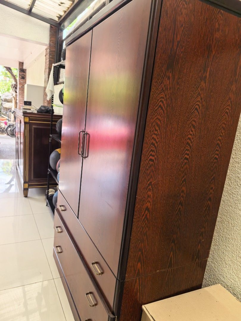 Wooden Wardrobe with Drawers (Category: Shelves, Cabinets & Racks) located in Las Pinas. Submitted by teampeewee888 (Listing ID 1437660118, Image 2). Description: - Wooden wardrobe with two doors and two drawers - Features multiple shelves and storage compartments - Dark wood finish - Gold-colored handles - Well-maintained condition - Ample storage space for clothes and other items.