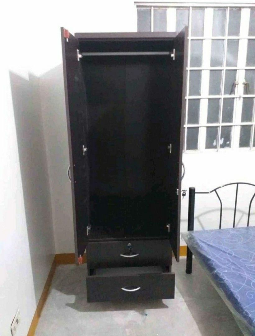 Wooden Wardrobe with Drawers (Category: Shelves, Cabinets & Racks) located in Manila. Submitted by jerrymieborda05 (Listing ID 1437746092, Image 2). Description: - Dark brown wooden wardrobe - Two doors and two drawers - Includes a hanging rod - Features a lock and handles - Ideal for bedroom storage - Tall with a simple design.