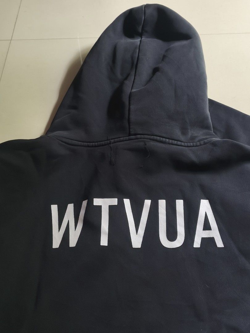 WTAPS Hoodie Black (Category: Hoodies) located in Taytay. Submitted by Rakeeeem (Listing ID 1437620250, Image 3). Description: - Black WTAPS hoodie - Features WTAPS logo on chest - WTVAU logo on back - Shows wear on cuffs and hem - Made of thick, dark fabric honest issue ribbings may fade part.