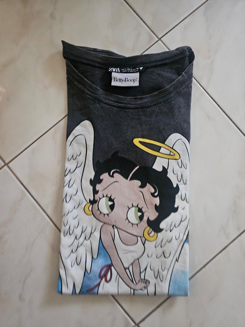 Zara Betty Boop Graphic Tee (Category: Shirts) located in Lupao. Submitted by selahthriftedclothing (Listing ID 1437594239, Image 3). Description: - Zara black t-shirt - Features a Betty Boop graphic with angel wings - Size: Medium (based on tag) - Short sleeves, round neckline - Faded/vintage look.