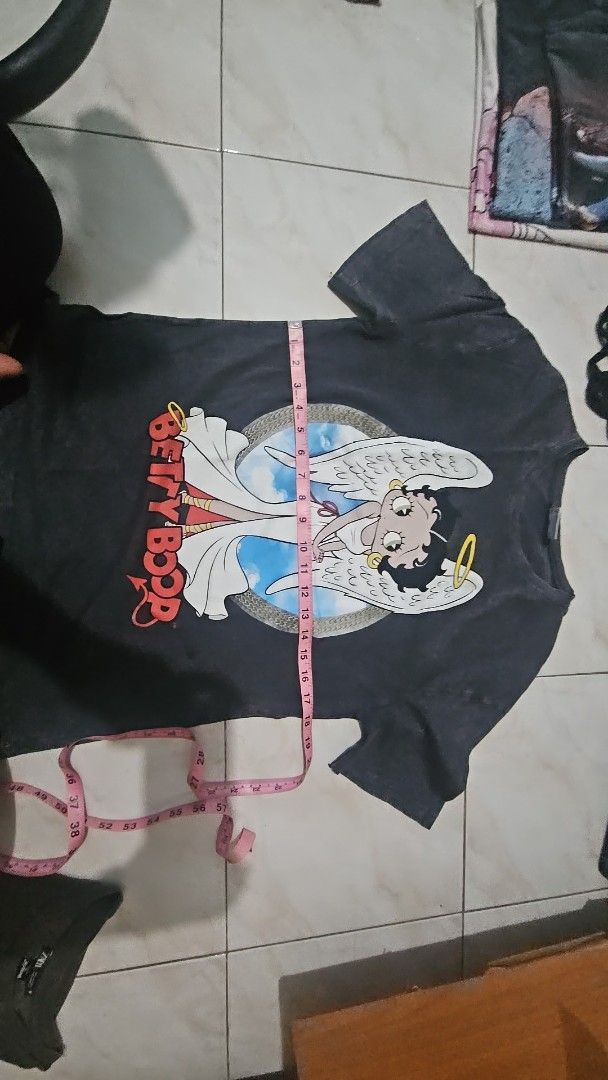 Zara Betty Boop Graphic Tee (Category: Shirts) located in Lupao. Submitted by selahthriftedclothing (Listing ID 1437594239, Image 2). Description: - Zara black t-shirt - Features a Betty Boop graphic with angel wings - Size: Medium (based on tag) - Short sleeves, round neckline - Faded/vintage look.
