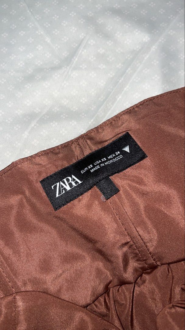 Zara Bow Dress XS (Category: Dresses) located in Quezon City. Submitted by sr_1521 (Listing ID 1437689646, Image 3). Description: Brown strapless dress from Zara. Features a large bow detail at the bust. The dress has a flared skirt. Size XS. Made in Morocco. Wore this twice only! .