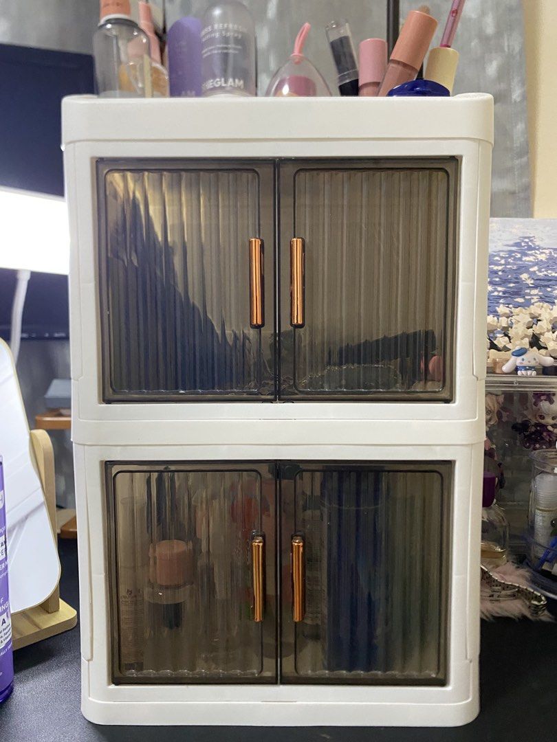 2-Layer Makeup Organizer with Dual Doors (Category: Makeup) located in Manila. Submitted by margielyn31 (Listing ID 1437902474, Image 2). Description: 2-layer makeup organizer features a dual-door design with sleek golden handles. It provides top storage and ample space for cosmetics and skincare products. The organizer is 38.7cm high and 24cm wide, with a depth of 18.5cm. It is perfect for keeping your beauty essentials organized and easily acce